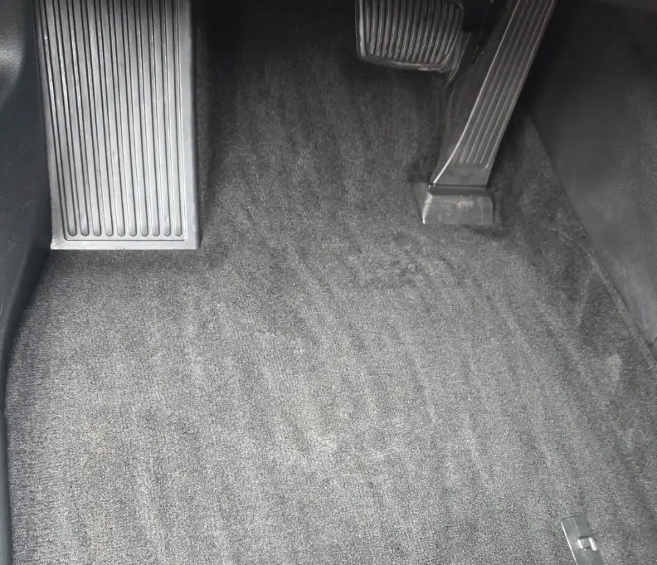 vehicle footwell carpet after a Statewood interior detail, salt and debris removed